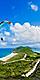 Man Paragliding by the Coast. Family Sitting by the Coast. Basseterre, St. Kitts Nevis 