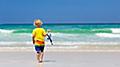 Child snorkeling on tropical beach. Kids snorkel.