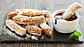 Hot chocolate surrounded by churros. 