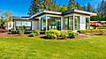 Contemporary home exterior on lakeshore with flat roof and large feature windows