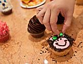 Woman Decorating her Cupcake as a Bear