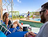 Couple Enjoying Wine by the Cove Pool