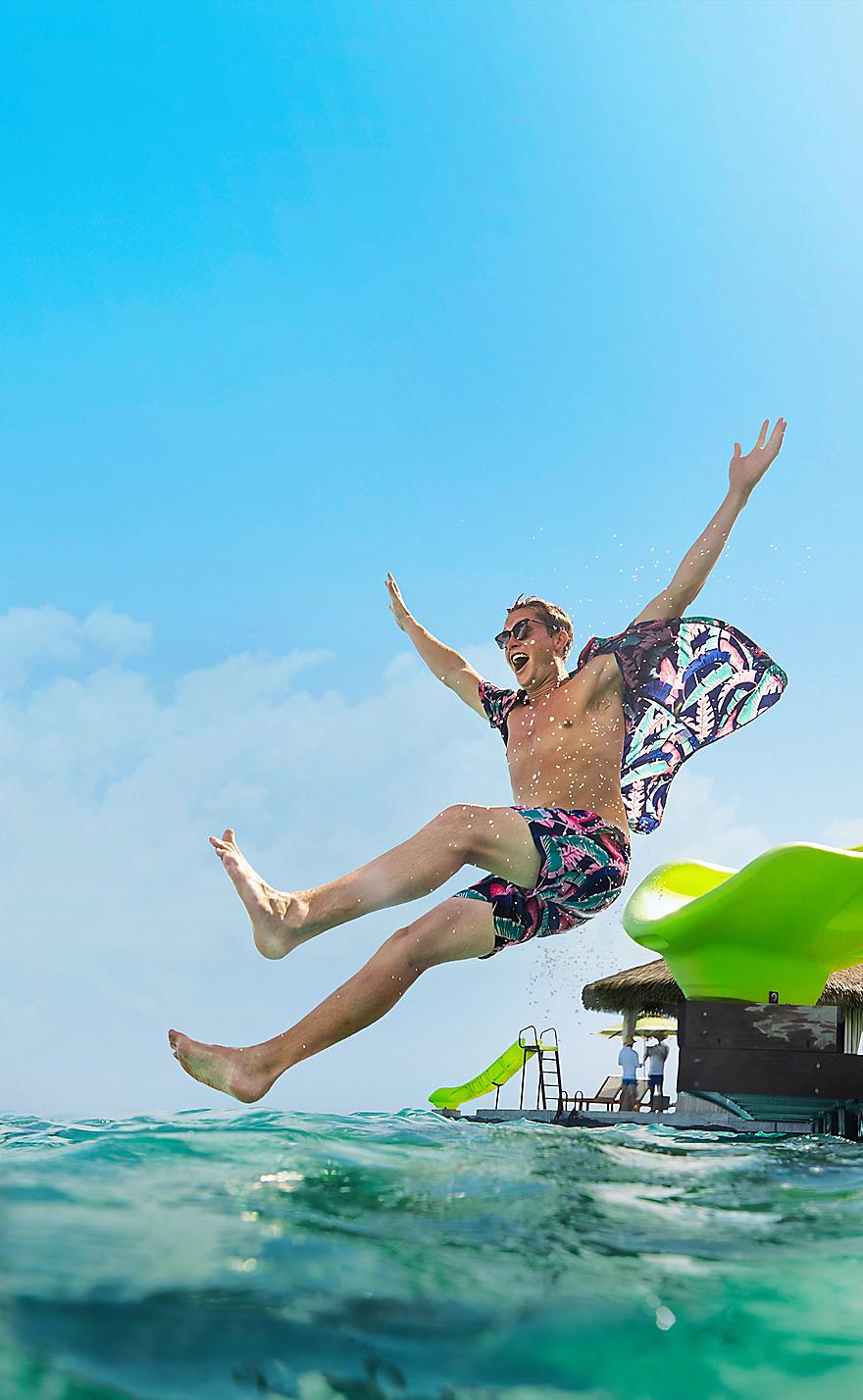 Man Jumping from Slide at CocoCay Cabana Banner 1040 520 FAM NF 2x