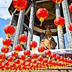 Red lanterns hanging from the buddha Guanyin statue in a Chinese temple in Penang, Malaysia