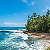 Wild waves hitting the shore of Manzanillo beach on a beautiful sunny day, near Puerto Limon, Costa Rica