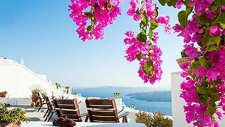 View of the sea from a beautiful terrace with flowers in Santorini, Greece